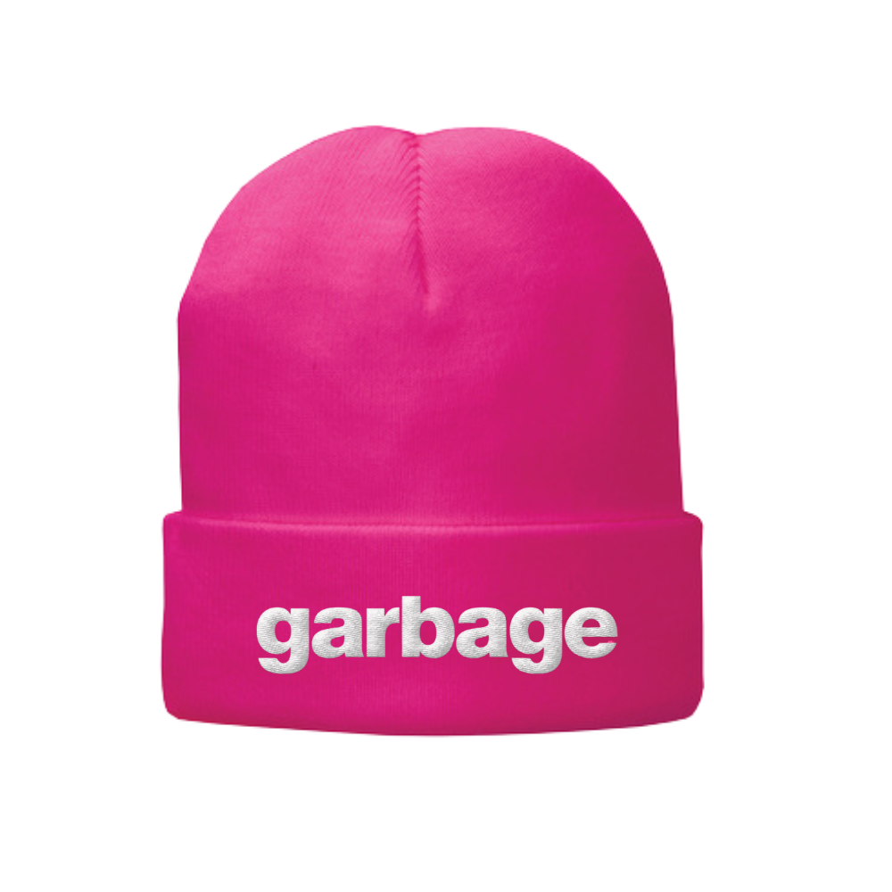 Bright pink beanie hat with ’garbage’ written in white text on the folded brim.
