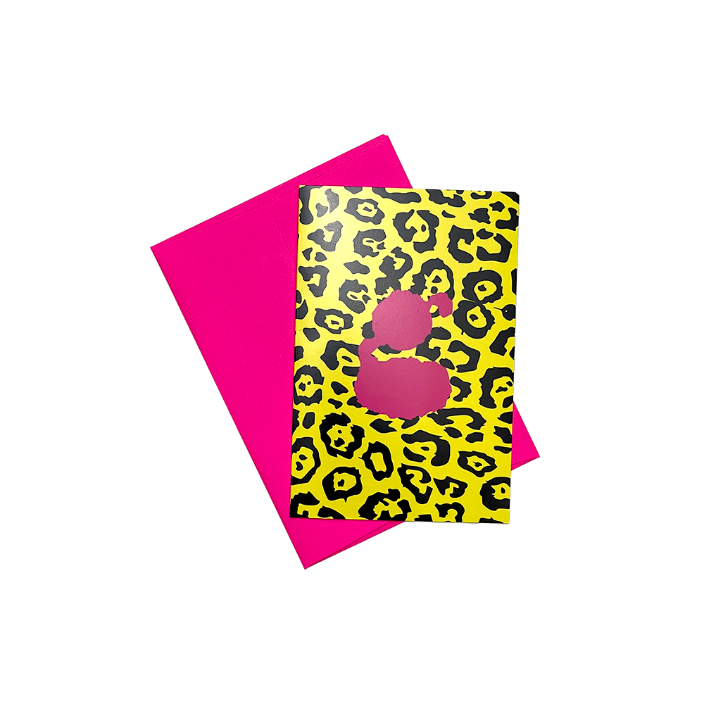 Greeting card with leopard print design and pink silhouette on yellow background, paired with solid pink envelope.