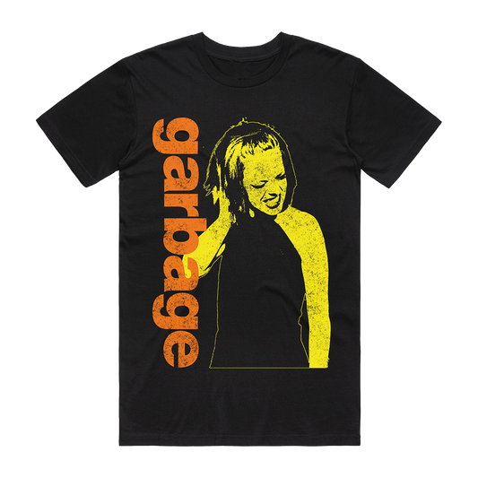Official Garbage Merchandise. 100% black cotton t-shirt with a vintage photo of Shirley Manson on the front in yellow and an orange Garbage logo.