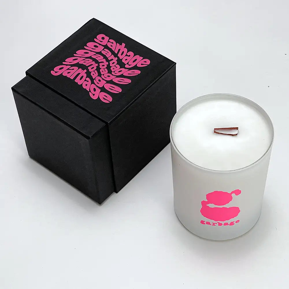 White frosted glass candle jar with pink ’garbage’ logo and wooden wick